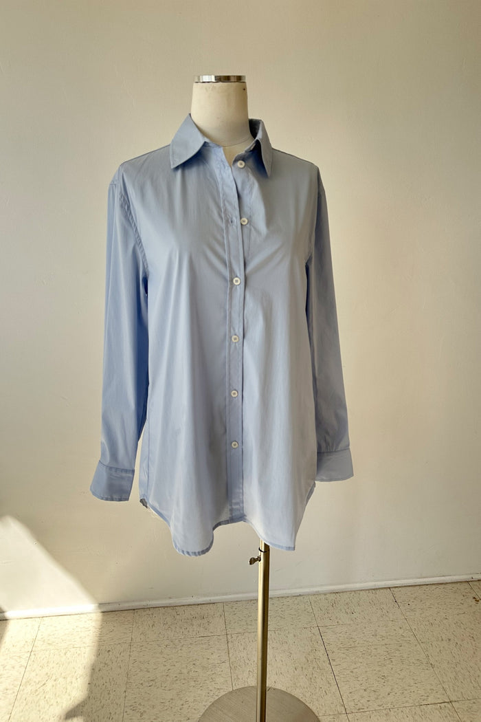 Light blue shirt on a mannequin against a plain background