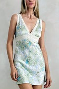 Woman wearing a floral dress against a plain background