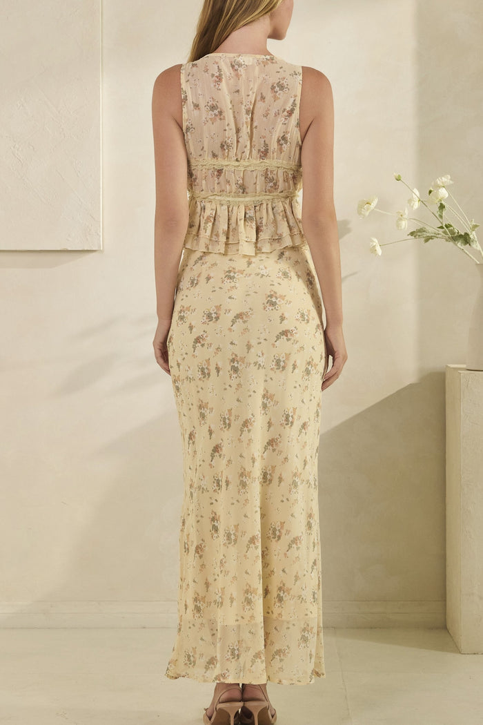 Woman wearing a floral dress in a minimal indoor setting