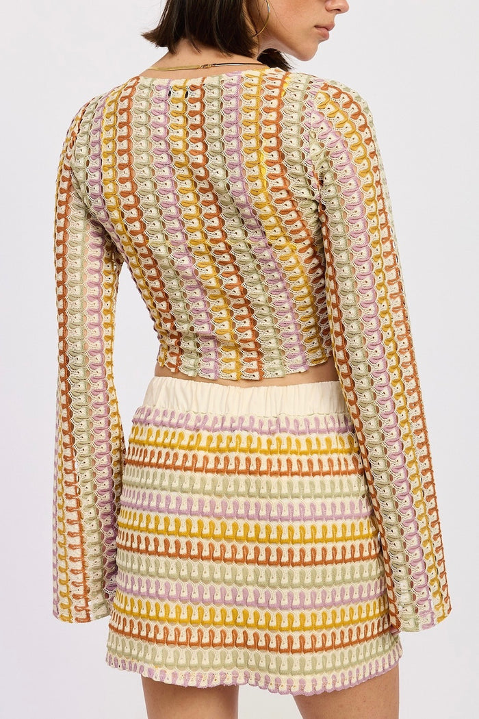 Woman wearing a colorful patterned outfit on a white background