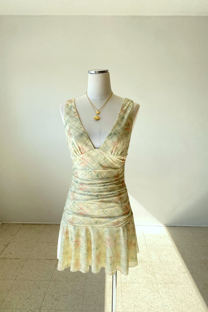 Floral dress on a mannequin against a plain background