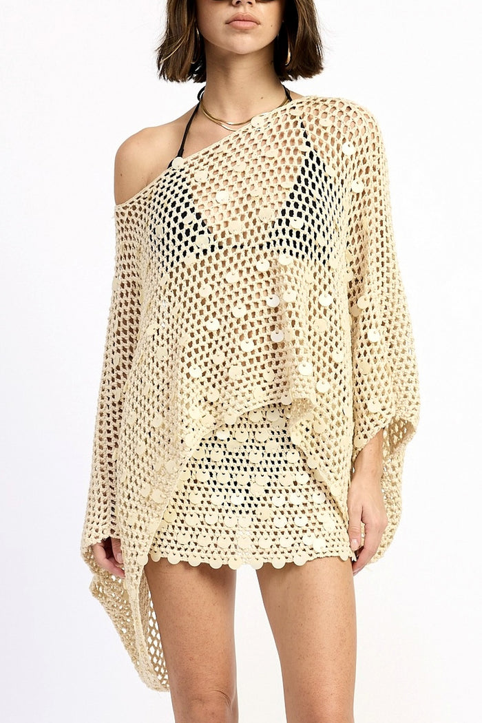 Woman wearing a beige crochet cover-up on a white background
